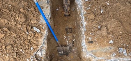 Open pit exposing a service line for inspection