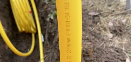 New yellow gas service line in an open trench