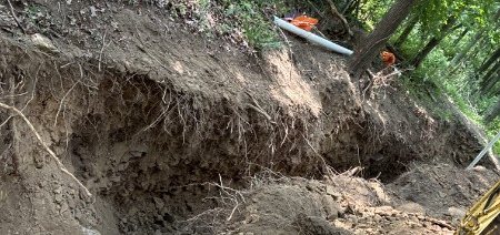 Excavation exposing a sewer lateral connection