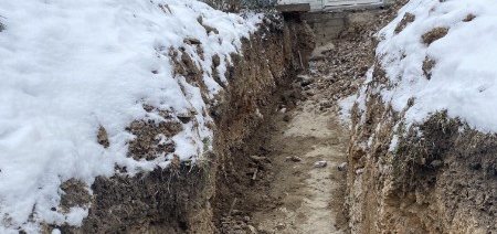 Trench opened alongside a house for a water service line