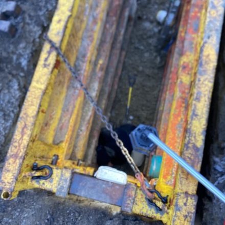Trench box set into an open excavation