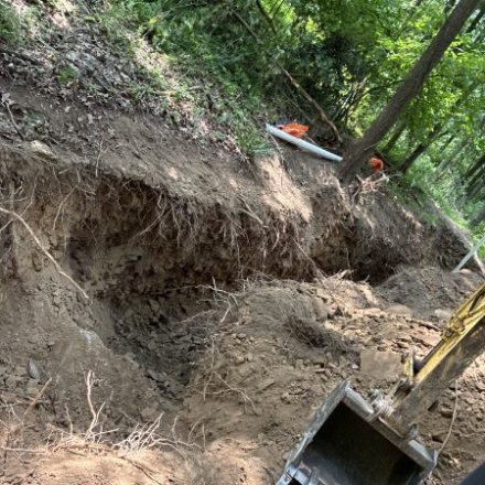 Deep excavation exposing a sewer connection